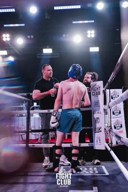 Alex (right) and his own coach in the corner, working with a fighter between rounds.
